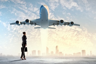 a woman standing in front of an airplane